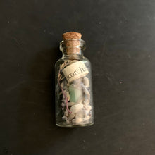 Load image into Gallery viewer, Small glass bottle with cork lid containing small stones and a label on a dark background