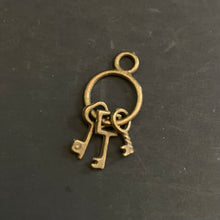 Load image into Gallery viewer, Bronze key charm on a black background