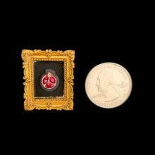 Load image into Gallery viewer, Small framed artwork with red stones next to a quarter for scale on a black background