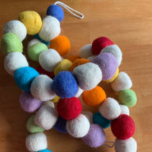 Load image into Gallery viewer, Colorful felt ball garland with soft, round felted wool balls for holiday or boho decor. 6 foot long. displayed coiled on wood table. Handmade by Ah! The Element of Surprise