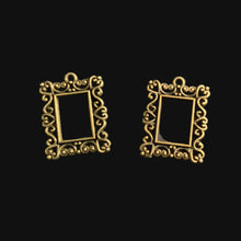 Load image into Gallery viewer, Two small ornate gold frames on a dark gray background