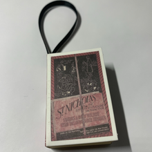 Load image into Gallery viewer, Bookworm's Holiday Ornament. The ornament is an open book; there's space to write a special message or add a personal touch. It's a perfect addition to your holiday decor, especially for book lovers and literary enthusiasts.