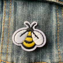 Load image into Gallery viewer, Embroidered bumble bee iron-on patches with bright yellow and black stripes and white wings, displayed on a denim jacket.
