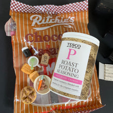 Load image into Gallery viewer, Ritchie's chocolate packaging with Tesco roast potato seasoning jar on a dark background