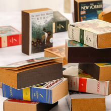 Load image into Gallery viewer, Unveil the charm of our vintage-inspired notebooks, nestled in a delightful pile in this photo. Each notebook is a delightful surprise, boasting unique covers featuring classic magazine and book designs. With 122 pocket-sized pages, it's your go-to for spontaneous notes, creative brainwaves, or a cherished daily diary. Crafted with rustic kraft paper, it adds a touch of nature to your everyday. Embrace the unexpected and let your ideas flow on these captivating pages.