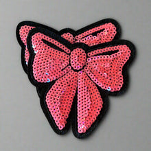 Load image into Gallery viewer, Two pink sequin bow iron-on patches displayed together
