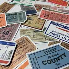Load image into Gallery viewer, Add a touch of classic rock cool and international travel to your belongings with this pack of vintage-looking travel, concert, and sporting event ticket stickers! These stickers are perfect for embellishing laptops, luggage, water bottles, scrapbooks, notebooks, journals, and bikes. The pack includes 48 high-quality decals