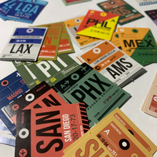 Load image into Gallery viewer, Mini Airport Code Travel, Vacation, Scrapbooking stickers. Measure 1". Advertising destinations such as PHX, SAN, LAX, NRT, AUS, ORD, LGA, PIT, AMS,MEX, PHL, BOS. US an international airports.