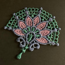 Load image into Gallery viewer, Decorative lace patch with green, pink, and gray colors on a dark background