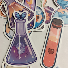 Load image into Gallery viewer, Charming cartoon magical scene in bottles stickers. Pack of 50, Approximately 2 inches each. Beautiful colors and quality graphics. Moon, Sun, Fruit, Clouds, Mountains in test tubes, coffee cups, teacup, beakers, jars, and cans.