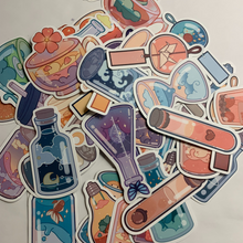 Load image into Gallery viewer, Charming cartoon magical scene in bottles stickers. Pack of 50, Approximately 2 inches each. Beautiful colors and quality graphics. Moon, Sun, Fruit, Clouds, Mountains in test tubes, coffee cups, teacup, beakers, jars, and cans.