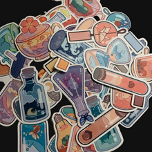 Load image into Gallery viewer, Charming cartoon magical scene in bottles stickers. Pack of 50, Approximately 2 inches each. Beautiful colors and quality graphics. Moon, Sun, Fruit, Clouds, Mountains in test tubes, coffee cups, teacup, beakers, jars, and cans.