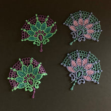 Load image into Gallery viewer, Four embroidered lace patches on a dark background