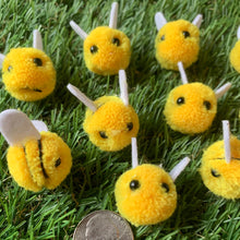 Load image into Gallery viewer, Small, fuzzy bee decorations with black stripes and felt wings for spring crafts shown with coin for size referece.