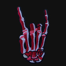 Load image into Gallery viewer, Red embroidered iron-on skeleton hand patch on white background.