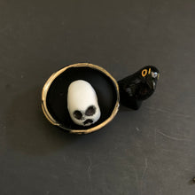Load image into Gallery viewer, Black and white skull in a scrying bowl with a raven figurine on a dark surface
