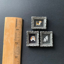 Load image into Gallery viewer, Three miniature silver picture frames with small animal illustrations, shown next to a wooden ruler on a dark gray background.
