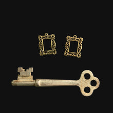 Load image into Gallery viewer, Two decorative key-shaped frames and a vintage-style key on a dark surface
