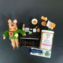 Load image into Gallery viewer, Element Ah! Dessie the reindeer curiosity box open to show miniature piano, potatoes, pint, and Irish props on a dark matte background
