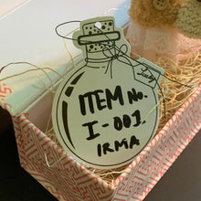 Load image into Gallery viewer, Small stuffed skunk animal in a decorative box with a label on a dark background
