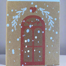 Load image into Gallery viewer, Close-up of paper cottage house box with window, snow, heart, and evergreen bough details.
