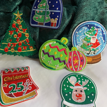 Load image into Gallery viewer, Elevate your holiday spirit and DIY creativity with our Christmas Decorative Embroidered Patches 6/pc set. This collection of festive patches features iconic Christmas symbols – a Christmas Tree, two Snowglobes, a Holiday Ornament, a calendar page, and Rudolph the Red-Nosed Reindeer – perfect for adding a touch of yuletide charm to your clothing, stockings, gifts, and Ugly Sweaters.
