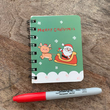 Load image into Gallery viewer, Green Santa Reindeer Mini Spiral Notebook, Lined pages on wood table
