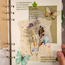 Load image into Gallery viewer, DIY project for junk journal created using clear bottle stickers from elementah.com. Wildflowers and butterflies are held in place on the page.
