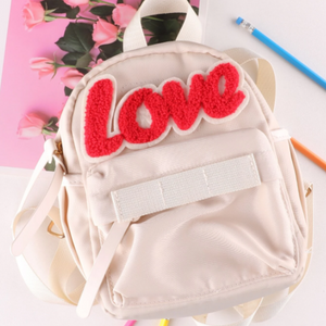 red hook loop love patch on pink backpack with pink roses and pencils. 