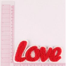 Load image into Gallery viewer, hook loop red love iron on patch against a ruler
