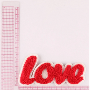 hook loop red love iron on patch against a ruler