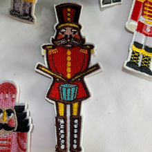 Load image into Gallery viewer, 9 Nutcracker Patches Assorted. Iron On. Detailed and colorful nutcracker designs. Customize dance bags, jeans, hoodies, or coats. Sew them onto pillows, scarves, or any material for some instant holiday fun! elementah.com
