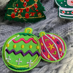 Elevate your holiday spirit and DIY creativity with our Christmas Decorative Embroidered Patches 6/pc set. This collection of festive patches features iconic Christmas symbols – a Christmas Tree, two Snowglobes, a Holiday Ornament, a calendar page, and Rudolph the Red-Nosed Reindeer – perfect for adding a touch of yuletide charm to your clothing, stockings, gifts, and of course, Ugly Sweaters.