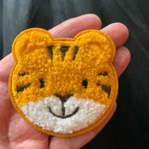 Baby Tiger patch embroidered glue on applique for kids clothes, diy. displayed on hand. 