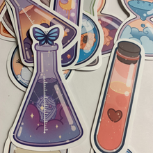 Load image into Gallery viewer, Charming cartoon magical scene in bottles stickers. Pack of 50, Approximately 2 inches each. Beautiful colors and quality graphics. Moon, Sun, Fruit, Clouds, Mountains in test tubes, coffee cups, teacup, beakers, jars, and cans.
