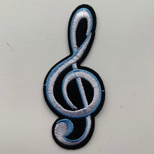 Load image into Gallery viewer, Large black and white embroidered treble clef iron-on patch in white, blue, and black, measuring 3.7 inches x 1.6 inches. Displayed on a white surface.
