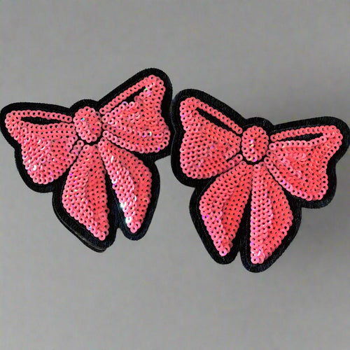 Two pink sequin bow patches displayed together