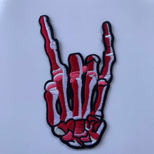 Load image into Gallery viewer, Red embroidered iron-on skeleton hand patch on white background.
