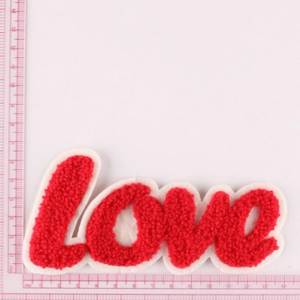 love patch iron on red yarn loop against pink rulers