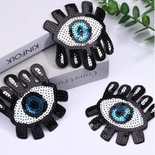 Load image into Gallery viewer, sequin wide eye blue eye with lashes patches. These patches measure 3&quot; x 3.5&quot; each, making them the perfect size to add to your clothes, bags, and shoes. The patches are made of high-quality sequins that add a fun and playful touch to your look.

